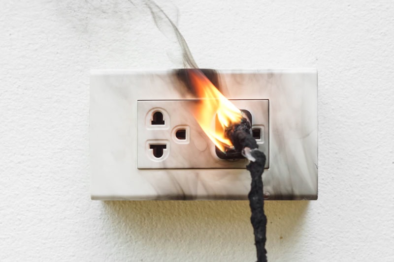 An outlet that has caught on fire.