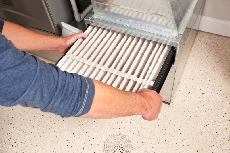 Man changing out a furnace filter