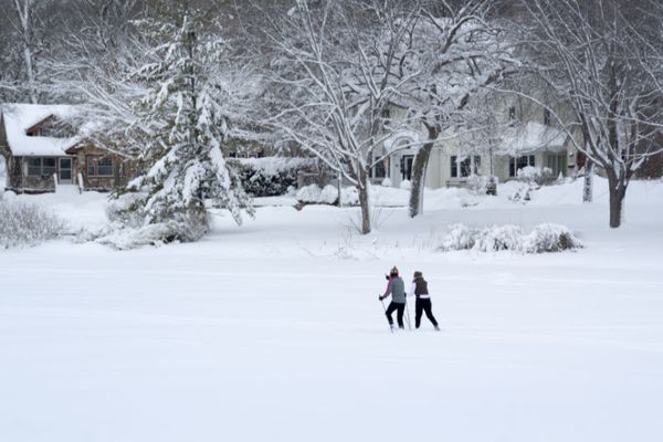 Two people in the snow. How Can I Lower My Heating Costs?